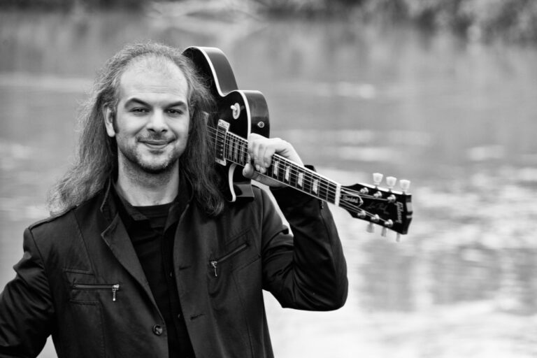 Miltos Marathon with guitar in river